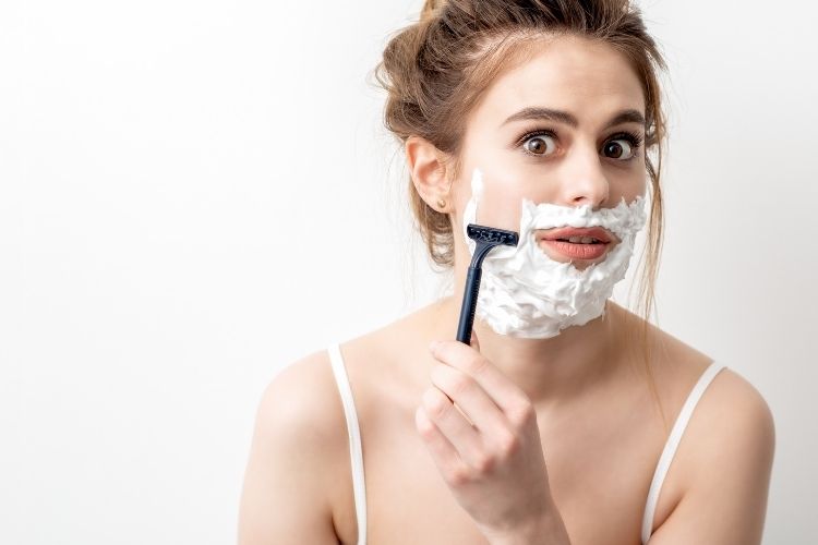 women shaving their face